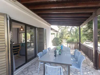 a patio with a table and chairs on a porch at Holiday Home Ferienvilla Mo 3 für 10 Personen in Agia Napa by Interhome in Ayia Napa