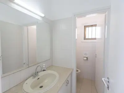 a white bathroom with a sink and a toilet at Holiday Home Ferienvilla Mo 3 für 10 Personen in Agia Napa by Interhome in Ayia Napa
