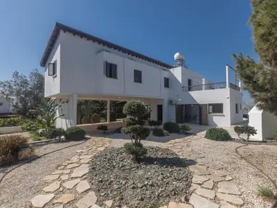 a large white house with a stone driveway at Holiday Home Ferienvilla Mo 3 für 10 Personen in Agia Napa by Interhome in Ayia Napa