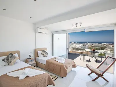 a bedroom with two beds and a balcony with a view at Apartment Schöne Wohnung in Ayia Napa mit Garten by Interhome in Ayia Napa