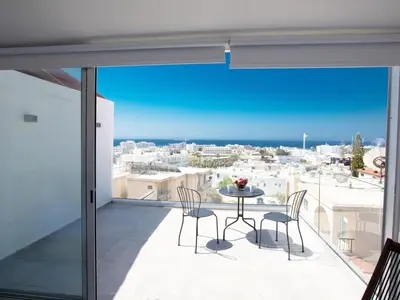a balcony with a table and chairs and a view of the city at Apartment Schöne Wohnung in Ayia Napa mit Garten by Interhome in Ayia Napa