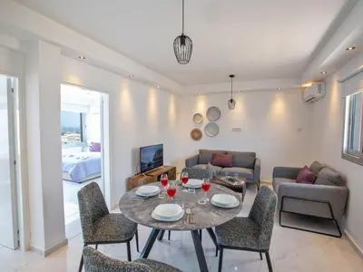 a living room with a table and chairs at Apartment Schöne Wohnung in Ayia Napa mit Garten by Interhome in Ayia Napa