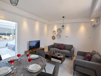 a living room with a table and a couch at Apartment Schöne Wohnung in Ayia Napa mit Garten by Interhome in Ayia Napa