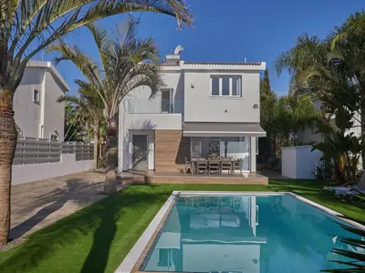 a villa with a swimming pool in front of a house at Holiday Home Moderne- geräumige Ferienvilla by Interhome in Ayia Napa