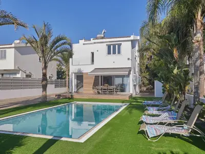 a villa with a swimming pool in front of a house at Holiday Home Moderne- geräumige Ferienvilla by Interhome in Ayia Napa