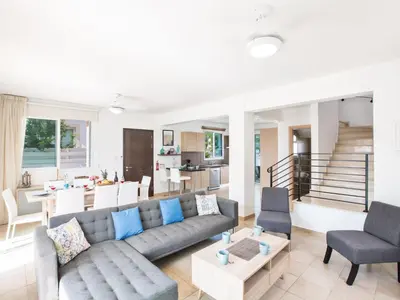 a living room with a couch and a table at Holiday Home 3-Schlafzimmer-Villa mit privatem Pool by Interhome in Protaras