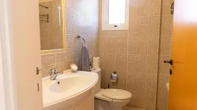a bathroom with a toilet and a sink at Penthouse Apartment - Sleeps 4 - Sea Views in Paralimni