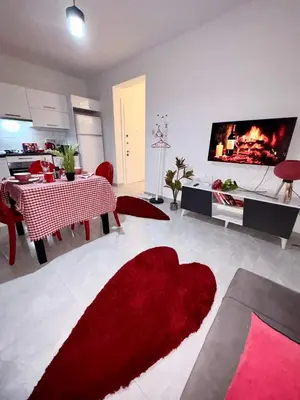 a living room with a red rug on the floor at Lapta Red 1 bedroom apartment