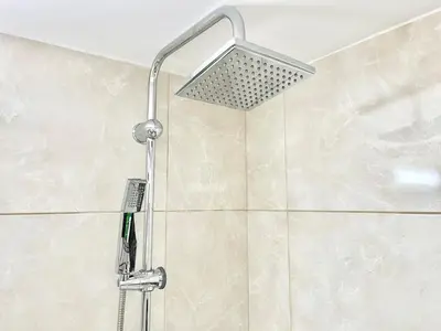 a shower with a shower head in a bathroom at Silver Blu APT - Beachside - Location - Office in Limassol