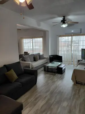 a living room with a couch and a table at Queen victoria sea view apartments in Larnaka