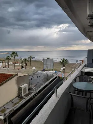 a view of the beach from the balcony of a building at Queen victoria sea view apartments in Larnaka