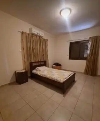 a bedroom with a bed and a flat screen tv at Maria's Garden House in Pelendri