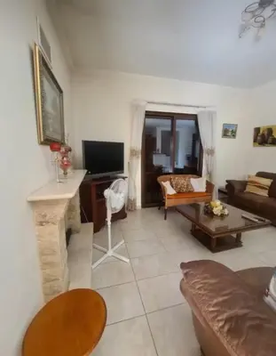 a living room with a couch and a fireplace at Maria's Garden House in Pelendri