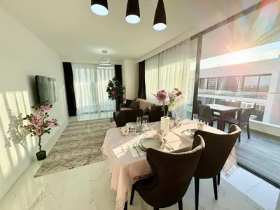 a dining room with a table and chairs at Brand new 2 bedrooms apartment in Grand Sapphire in İskele