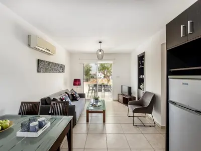 a living room with a couch and a table at Mythical Sands CB04 in Paralimni