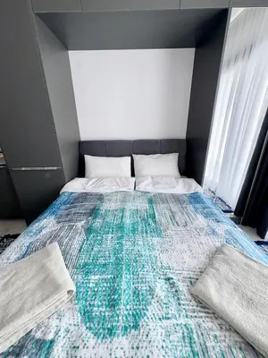 a bedroom with a bed with a colorful blanket on it at Riverside studio in Iskele in Dherinia