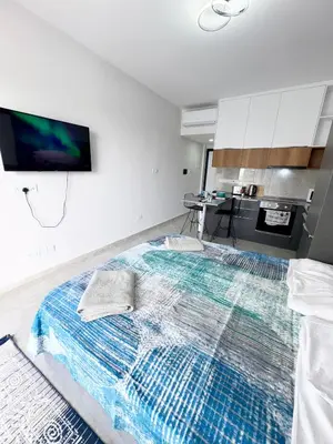 a large bed in a room with a tv on the wall at Riverside studio in Iskele in Dherinia