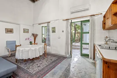 a kitchen with a table and a sink at Antonys Garden House in Episkopi Lemesou