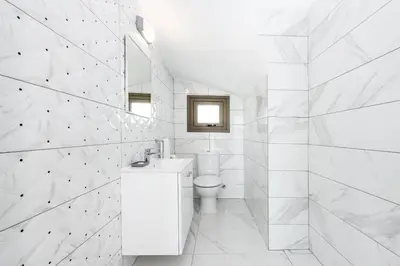 a white bathroom with a toilet and a sink at Villa Levanda #40 in Paralimni