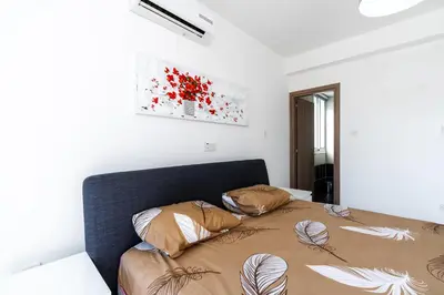 a bedroom with a bed with two pillows on it at White Pearl Villa Protaras 7 in Paralimni