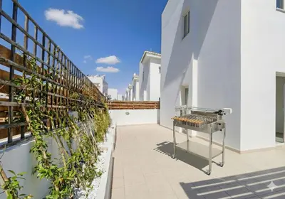 a barbecue grill on the side of a building at Fig Tree Beach Villa Five in Protaras