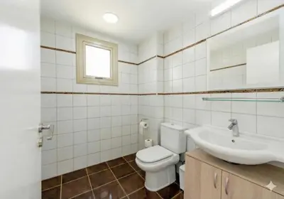 a bathroom with a toilet and a sink at Fig Tree Beach Villa Six in Protaras