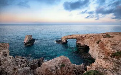 a cave in the ocean with rocks in the water at Fig Tree Beach Villa Six in Protaras