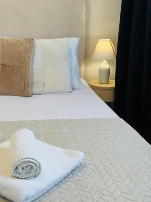 a bedroom with a bed with a towel on it at Makenzie View Penthouse in Larnaka
