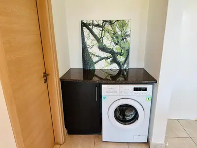 a washing machine in a room with a window at Beachfront Seaview Apartment in Paralimni