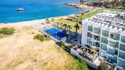 an aerial view of a building next to the ocean at Beachfront Seaview Apartment in Paralimni