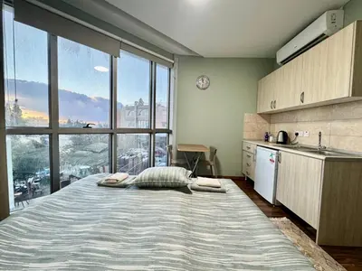 a large bed in a kitchen with a large window at Room in EkinAdademir Dorm North Cyprus in Nicosia