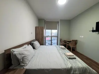 a bedroom with a large bed and a table at Room in EkinAdademir Dorm North Cyprus in Nicosia
