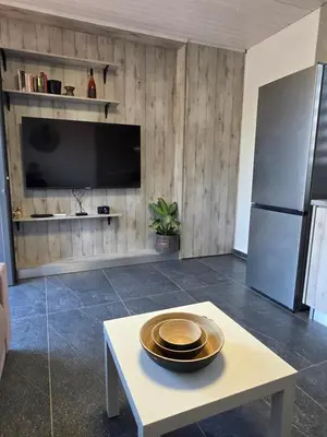 a living room with a table with a plate on it at Relaxing small home