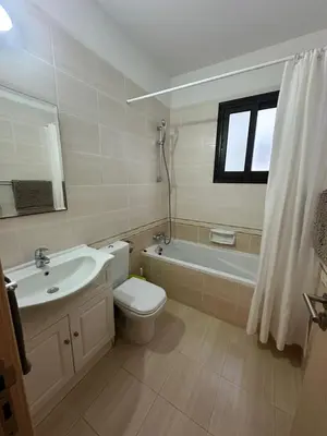 a bathroom with a toilet and a sink and a bath tub at Натали апарт in Paralimni