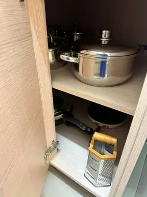 a cabinet with a pot and a pan and a tool at Натали апарт in Paralimni