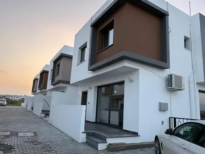 a white building with a black roof at Bohemian City Escape Villa in Nicosia