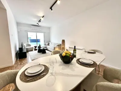 a dining room with a white table and chairs at STAY Aelia Apartment in Nicosia