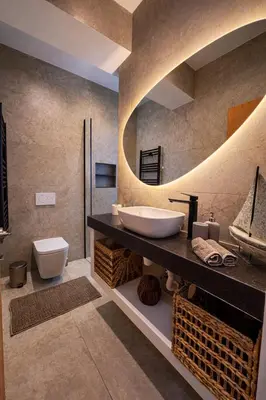 a bathroom with a sink and a toilet and a mirror at Modern Seaside Apartment Steps to the Beach in Pervolia