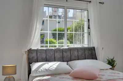 a bedroom with a large window and a bed with pillows at Oceanic Pearl Villa Deluxe - 200m from beach in Voroklini