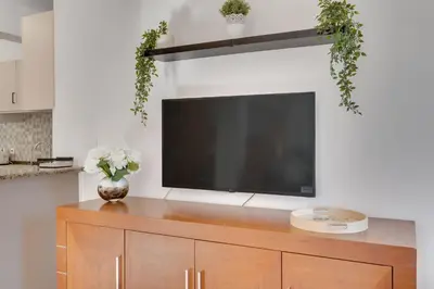 a flat screen tv sitting on top of a wooden cabinet at Oceanic Pearl Villa Deluxe - 200m from beach in Voroklini