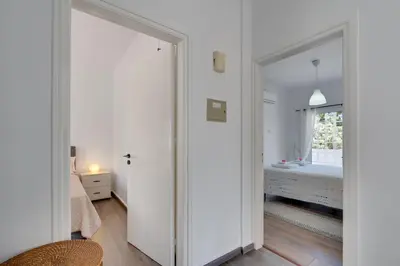 a bedroom with white walls and a sliding door at Oceanic Pearl Villa Deluxe - 200m from beach in Voroklini
