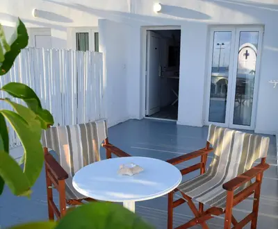 a table and chairs on a balcony with a table at Seaside Stay Room in Ayia Napa
