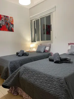 two beds sitting next to each other in a bedroom at Fiori Apartments in Paralimni