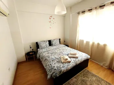 a bedroom with a bed with towels on it at City Center Walking to the Beach 2 Bedrooms in Larnaka