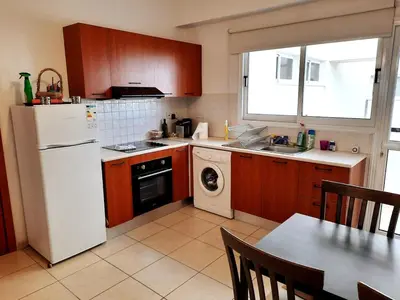 a kitchen with a white refrigerator and a dishwasher at City Center Walking to the Beach 2 Bedrooms in Larnaka