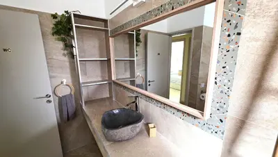 a bathroom with a sink and a mirror at Warm Design 3BR, Beach 7-min walk, Peaceful in Larnaka