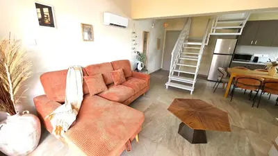 a living room with a couch and a table at 3BR Shared Apt - Beach 7-min walk, Peaceful in Larnaka
