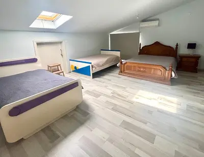 a bedroom with two beds and a skylight at Spacious 1 bedroom apartment with an attic bedroom in Strovolos