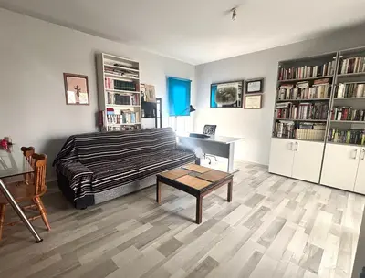 a bedroom with a bed and a desk and book shelves at Spacious 1 bedroom apartment with an attic bedroom in Strovolos
