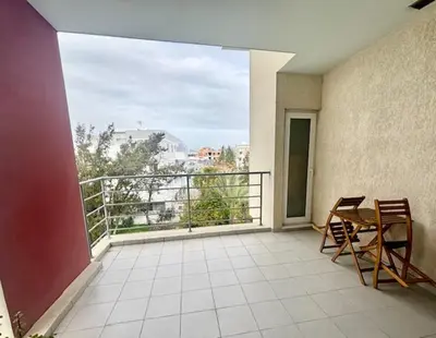 a balcony with a table and chairs on a balcony at Spacious 1 bedroom apartment with an attic bedroom in Strovolos